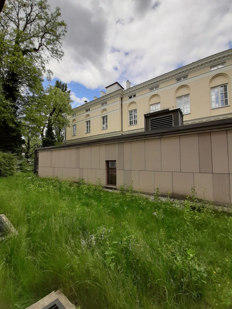 building and green long grass