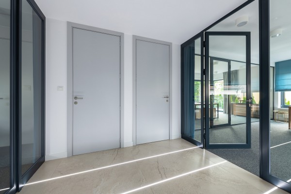 two grey doors and hallway